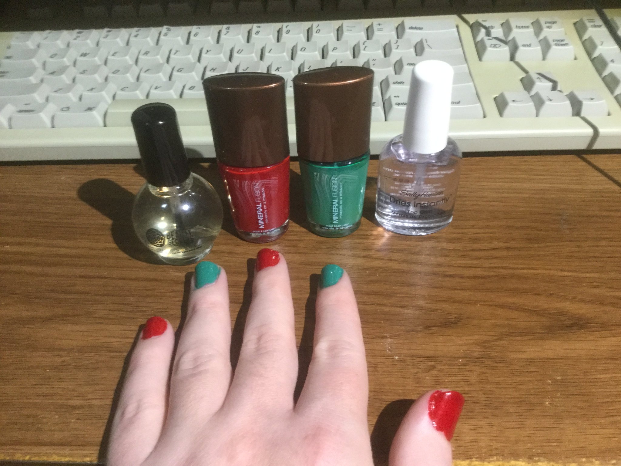 Mineral Fusion red and green nail polishes, on alternating nails.